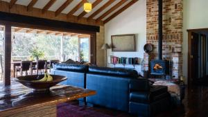 a living room with a blue couch and a fireplace at Mountain View Farm in Portland