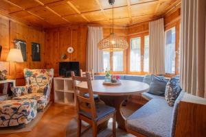 a living room with a table and a chair at Haus Berta, Montafon in Partenen