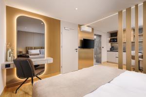 a bedroom with a bed and a desk and a chair at Guest House Jezero in Most na Soči