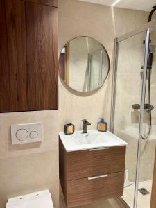 a bathroom with a sink and a mirror at Studio Noélie in Antibes