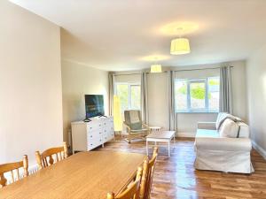 a living room with a dining room table and a couch at Bay Breeze Hideaway in Cobh