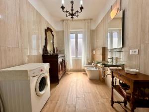 a bathroom with a washing machine and a sink at La Fenice - Studio Flat in Finale Ligure