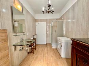 a bathroom with a sink and a washing machine at La Fenice - Studio Flat in Finale Ligure