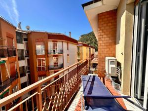 an apartment balcony with a hammock on the ledge of a building at La Fenice - Studio Flat in Finale Ligure