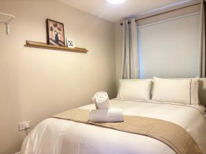 a bedroom with a bed with a alarm clock on it at Bay Breeze Hideaway in Cobh
