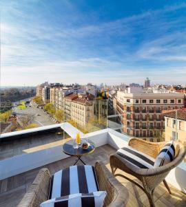 a balcony with a view of a city at H10 Puerta de Alcalá in Madrid