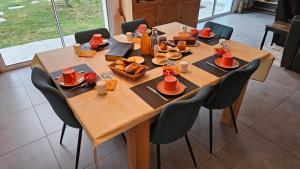 a wooden table with food and bread on it at Laubertière in Marennes