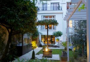 a house with a garden in front of it at Villa du Square, Luxury Guest House in Paris