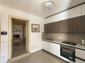 a kitchen with a sink and a stove top oven at Casa Luna in Tricase