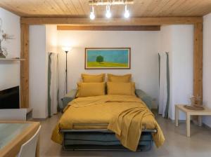 a bedroom with a bed with a yellow bedspread at Casa Luna in Tricase