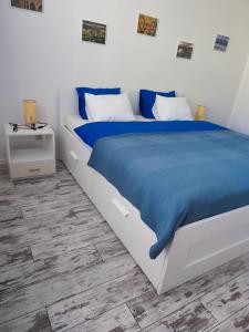 a bedroom with a large bed with a blue blanket at Villa Ondruš in Vernár