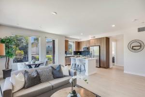 a living room with a couch and a kitchen at Realm in Menlo Park