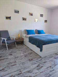 a bedroom with a bed and a chair at Villa Ondruš in Vernár +44 photos