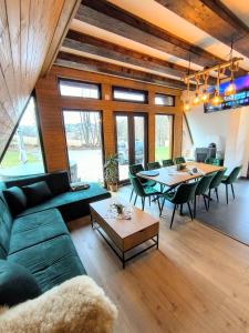 a living room with a couch and a table at Lunor House in Izvoare
