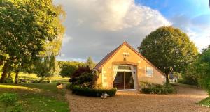 a small house in the middle of a yard at Gîte La Thibaud in Lavernat +24 photos