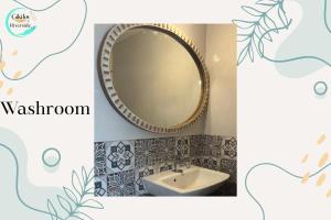 a bathroom with a mirror and a sink at Riverfront By Gikijoy in Agarvado +11 photos