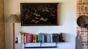 a book shelf with books and a painting on the wall at Mountain View Farm in Portland