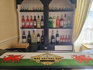 a bar with a display of bottles of wine at St. Hilary Guest House in Llandudno