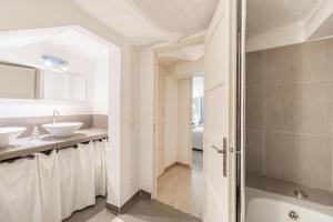 a white bathroom with two sinks and a shower at Cannes Guest House in Cannes +38 photos