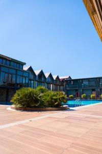 a resort with a swimming pool and a building at Green House Garden Park Hotel in Istanbul
