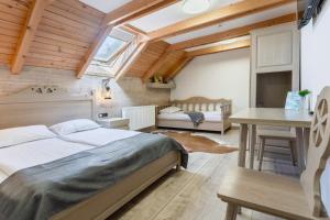 a bedroom with two beds and a table and a desk at Pensiunea Mama Cozonacilor in Bran +129 photos