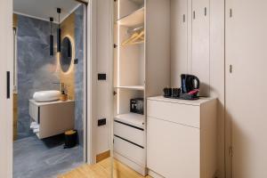 a closet with white cabinets and a sink in it at Guest House Jezero in Most na Soči +67 photos