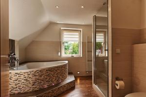 a large bathroom with a tub and a window at Zimmervermietung Vock in Eschwege +43 photos