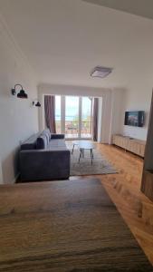 a living room with a couch and a table at Lukanov Apartments - Lake view in Ohrid