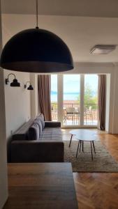 a living room with a couch and a table at Lukanov Apartments - Lake view in Ohrid