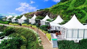 a row of white tents on a hill at Sunny's World Resort in Pune