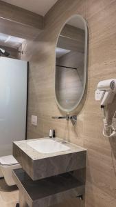 a bathroom with a sink and a mirror at Dine Residence in Himare +66 photos