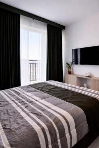 a bedroom with a large bed and a large window at Ocean View Studio Iloilo in Iloilo City