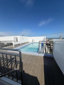 a balcony with a swimming pool on a building at Ocean View Studio Iloilo in Iloilo City