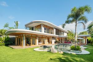 a large house with a curved roof at Uluwatu Zen Villas in Badung