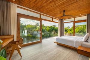 a bedroom with a bed and a large window at Uluwatu Zen Villas in Badung +93 photos