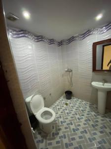 a bathroom with a toilet and a sink at Comfortable Luxury House in Merzouga