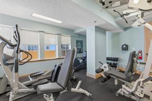 a gym with treadmills and ellipticals in a room at Atlantic Villas 402 in New Smyrna Beach