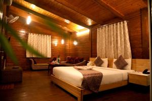 a bedroom with a bed in a wooden room at Sunny's World Resort in Pune