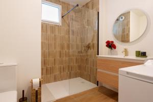 a bathroom with a shower with a glass door at L'Esplanade - T3 Design avec Parking et Mini-golf in Le Bouscat +12 photos