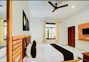 a bedroom with a bed and a ceiling fan at Hotel Namaste Pushkar in Pushkar
