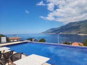 a swimming pool with a view of the water at Gümüş Yazar Hotel in Kaş