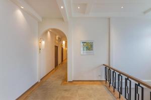a hallway with white walls and a stair case at Upstairs at Ton Ton in Bangkok