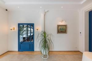 a room with a blue door and a plant at Upstairs at Ton Ton in Bangkok +19 photos