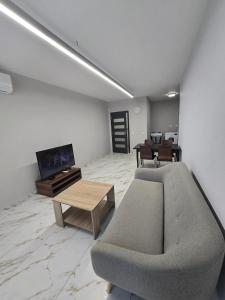 a living room with a couch and a coffee table at Icon Residence in Sofia