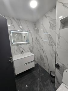 a bathroom with a white sink and a mirror at Icon Residence in Sofia