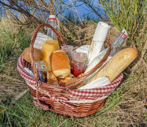 a basket filled with bread and other items on the ground at La Calèche Western in Lafarre