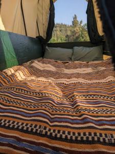 a close up of a bed in a tent at La Calèche Western in Lafarre