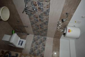 a bathroom with a shower and a toilet in a room at Devdaar Cottage Gangotri in Gangotri