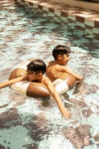 two young boys in a swimming pool at Teddies in Ahangama
