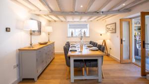 a dining room with a table and chairs at Garden Cottage in Chipping Campden +17 photos